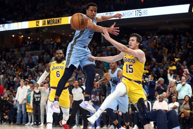 Apr 26, 2023; Memphis, Tennessee, USA; Los Angeles Lakers guard Austin Reaves (15) passes the ball as Memphis Grizzlies guard Desmond Bane (22) defends during the first half during game five of the 2023 NBA playoffs at FedExForum.