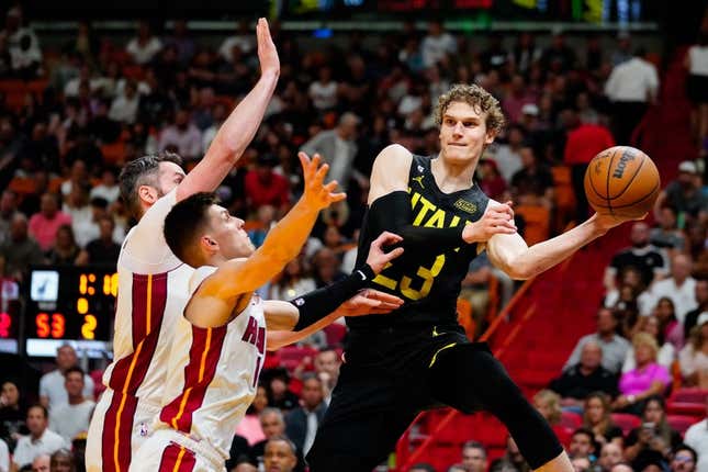 Mar 13, 2023; Miami, Florida, USA; Utah Jazz forward Lauri Markkanen (23) throws a pass as Miami Heat guard Tyler Herro (14) defends during the second quarter at Miami-Dade Arena.