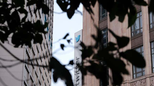 The silhouettes of leaves are shown in front of an image of Twitter's headquarters.