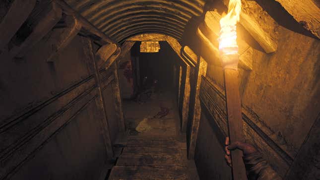 The Amnesia: The Bunker protagonist lights a dark passageway with a torch.