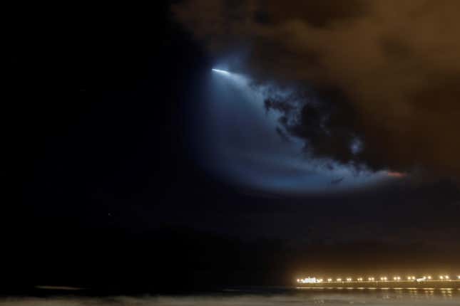 A SpaceX Falcon 9 rocket lights up the evening sky over Oceanside, California.