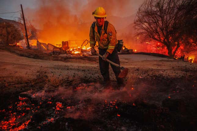 Ian Fremd, of the Beaumont Fire Department, takes down hot spots while battling the Fairview Fire on Monday, Sept. 5, 2022, near Hemet, California. 
