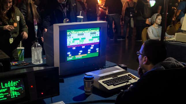 A guy playing Frogger on a very old computer