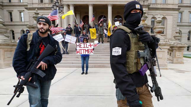 A group protests social distancing measures with guns in Lansing, Michigan on April 15th