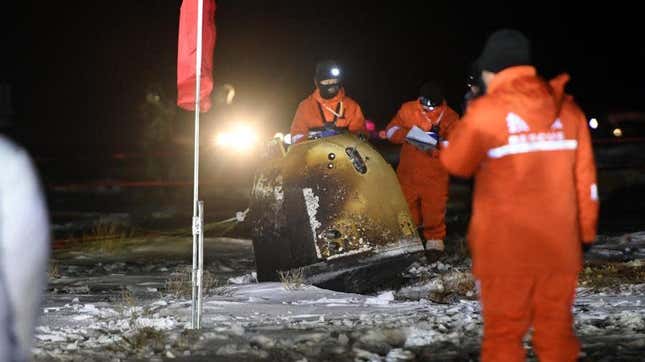 Ground teams recovering the re-entry capsule. 