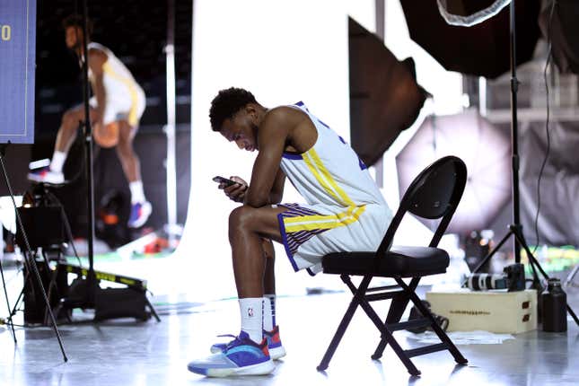 Andrew Wiggins #22 of the Golden State Warriors checks his phone during the Golden State Warriors Media Day at Chase Center on September 27, 2021 in San Francisco, California.