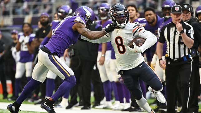 The Bears’ Damien Williams stiff arms the Vikings’ Patrick Peterson in the second half of the game at U.S. Bank Stadium on January 09, 2022 in Minneapolis.