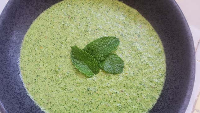 Aji Verde Sauce in stone-colored bowl garnished with mint leaves