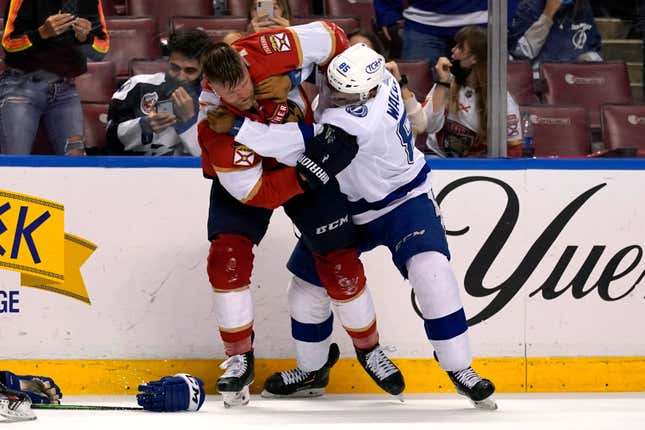 Florida Panthers defenseman Kevin Connauton, left, and Tampa Bay Lightning defenseman Daniel Walcott (85) fight during the second period of an NHL hockey game, Monday, May 10, 2021, in Sunrise, Fla. 