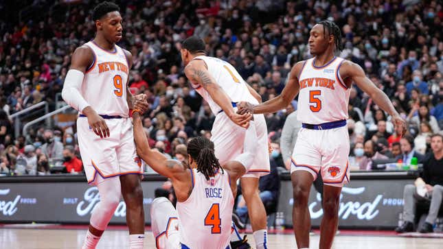 Derrick Rose is picked up by teammates RJ Barrett, Obi Toppin, and Immanuel Quickley during the second half of a game against the Raptors in Toronto.