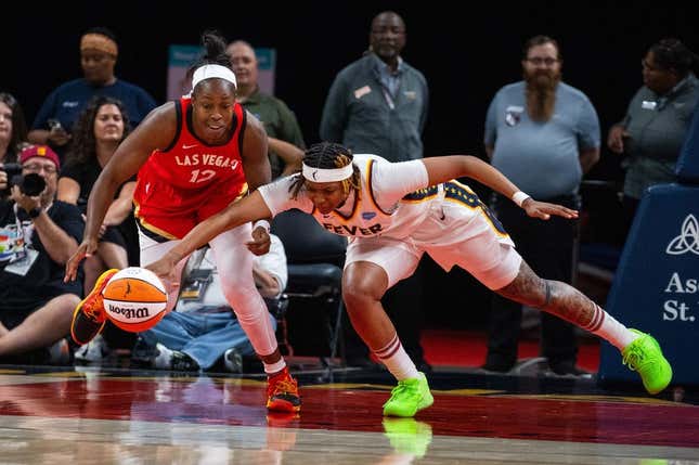 Jun 4, 2023; Indianapolis, Indiana, USA; Las Vegas Aces guard Chelsea Gray (12) and Indiana Fever forward NaLyssa Smith (1) fight for the ball in the second half at Gainbridge Fieldhouse.