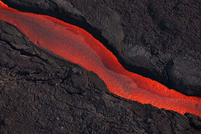 Lava flows from a fissure of Mauna Loa Volcano as it erupts on December 05, 2022 in Hilo, Hawaii. 