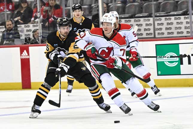 Apr 4, 2023; Newark, New Jersey, USA; New Jersey Devils center Jesper Boqvist (70) moves the puck against Pittsburgh Penguins center Ryan Poehling (25) during the first period at Prudential Center.