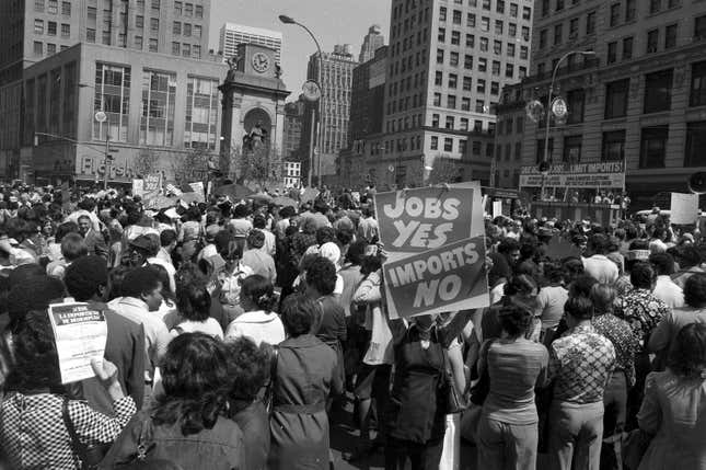 Thousands of New York's garment workers have left their midtown factory lofts and rally at Herald Square, during a demonstration against the import of clothing from overseas, on April 13, 1977. (AP Photo)