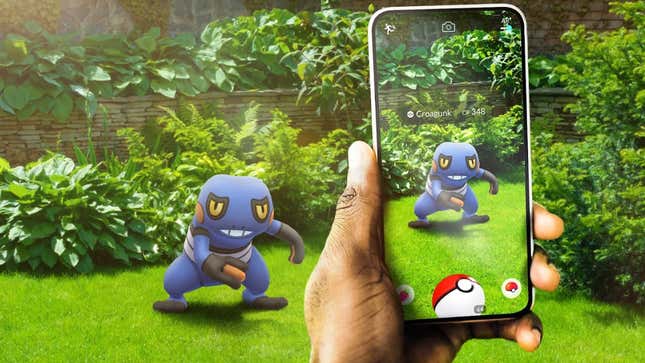 A man holds his phone up to catch a Croagunk in Pokémon Go.