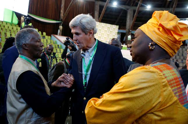Former U.S. Secretary of State John Kerry and former South Africa President Thabo Mbeki, observers for the general election in Kenya, greet each other next to former Senegalese Prime Minister Aminata Toure in a tally centre in Nairobi, Kenya.