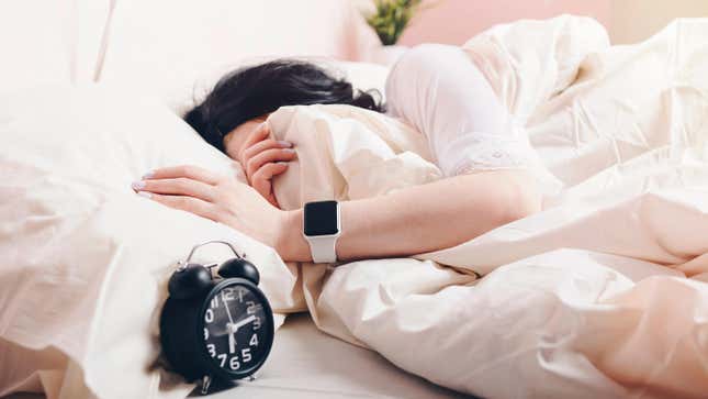 Woman sleeping in wearing Apple Watch