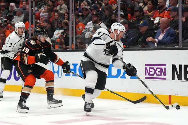 Apr 13, 2023; Anaheim, California, USA; LA Kings right wing Arthur Kaliyev (34) and Anaheim Ducks right wing Troy Terry (19) reach for the puck in the second period at Honda Center.