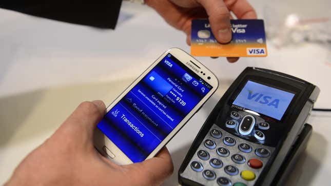 In this Feb. 27, 2013 photo, a man uses the NFC payment Visa system at the Mobile World Congress, the world's largest mobile phone trade show, in Barcelona, Spain. (AP Photo/Manu Fernandez)