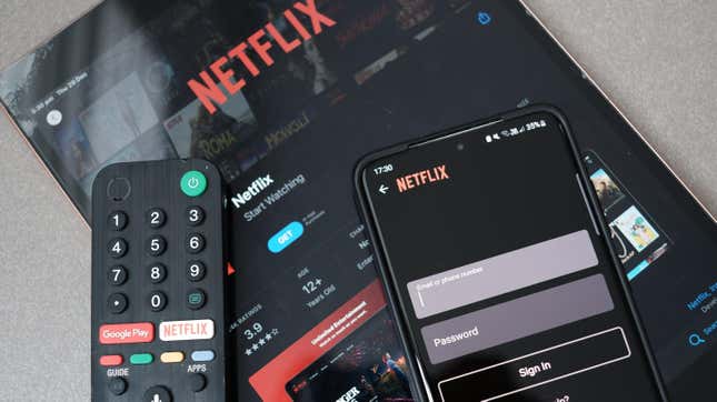 Several devices including a remote, phone and tablet all trying to log on to Netflix.