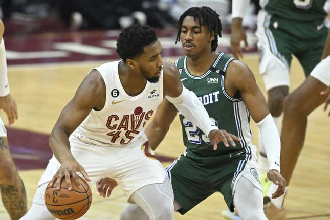 Mar 4, 2023; Cleveland, Ohio, USA; Cleveland Cavaliers guard Donovan Mitchell (45) dribbles beside Detroit Pistons guard Jaden Ivey (23) in the second quarter at Rocket Mortgage FieldHouse.