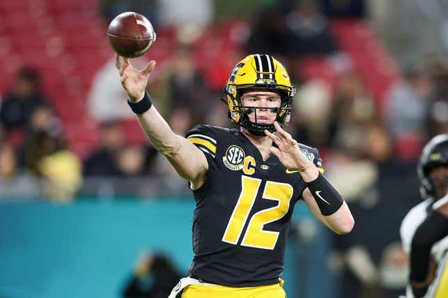 Dec 23, 2022; Tampa, Florida, USA; Missouri Tigers quarterback Brady Cook (12) throws a pass against the Wake Forest Demon Deacons during the first quarter in the 2022 Gasparilla Bowl at Raymond James Stadium.