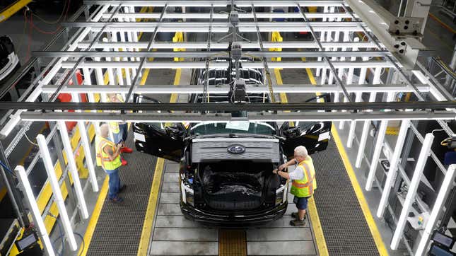 Black Ford truck in the final phases of the assembly line.