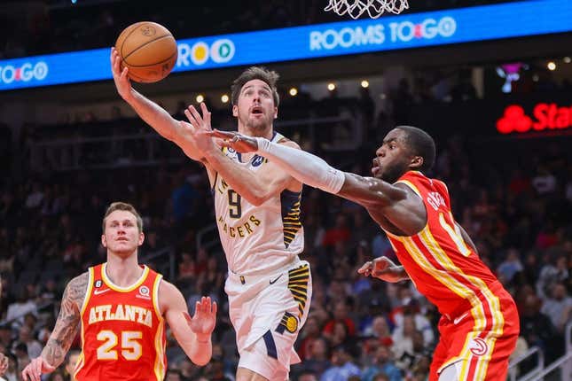 Mar 25, 2023; Atlanta, Georgia, USA; Indiana Pacers guard T.J. McConnell (9) shoots past Atlanta Hawks forward AJ Griffin (14) in the second quarter at State Farm Arena.