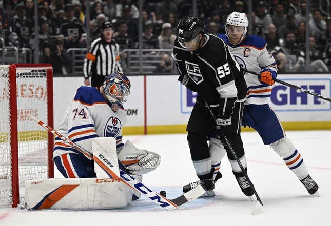 Apr 21, 2023; Los Angeles, California, USA; Edmonton Oilers goaltender Stuart Skinner (74) blocks a rebound shot by Los Angeles Kings center Quinton Byfield (55) as Oilers center Connor McDavid (97) sets behind him in the second period of game three of the first round of the 2023 Stanley Cup Playoffs at Crypto.com Arena.