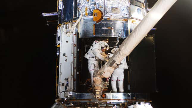 Astronauts service the Hubble Space Telescope