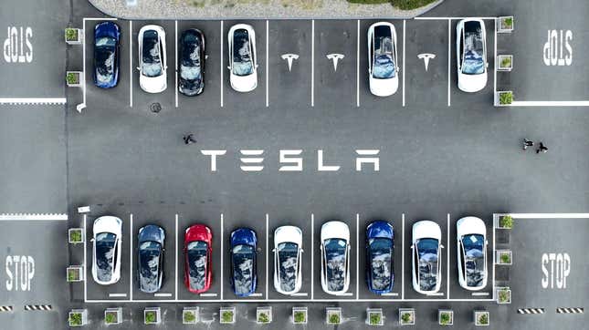 In an aerial view, Tesla cars sit parked in a lot at the Tesla factory on April 20, 2022 in Fremont, California.