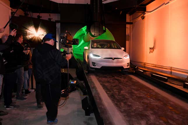 Elon Musk, co-founder and chief executive officer of Tesla Inc., arrives in a modified Tesla Model X electric vehicle during an unveiling event for the Boring Company Hawthorne test tunnel in Hawthorne, Calif., on Tuesday, Dec. 18, 2018. The tunnel, meant to be a "proof of concept," runs just over a mile under Musk's SpaceX headquarters in Hawthorne. (Robyn Beck/Pool Photo via AP)