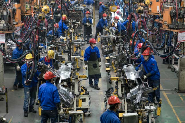 Workers assemble battery-powered automobiles with the help of automated and semi-automated processes at a BYD factory in Shenzhen.