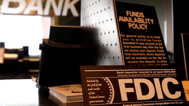 Signs explaining Federal Deposit Insurance Corporation (FDIC) and other banking policies on the counter of a bank in Westminster, Colorado November 3, 2009. 