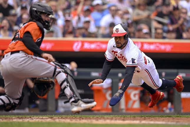 Jul 8, 2023; Minneapolis, Minnesota, USA; Minnesota Twins designated hitter Byron Buxton (25) dives for the plate and scores a run against the Baltimore Orioles during the sixth inning at Target Field.