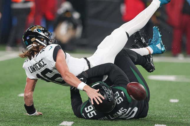 Dec 22, 2022; East Rutherford, New Jersey, USA; Jacksonville Jaguars quarterback Trevor Lawrence (16) is sacked by New York Jets defensive tackle Quinnen Williams (95) during the first half at MetLife Stadium.