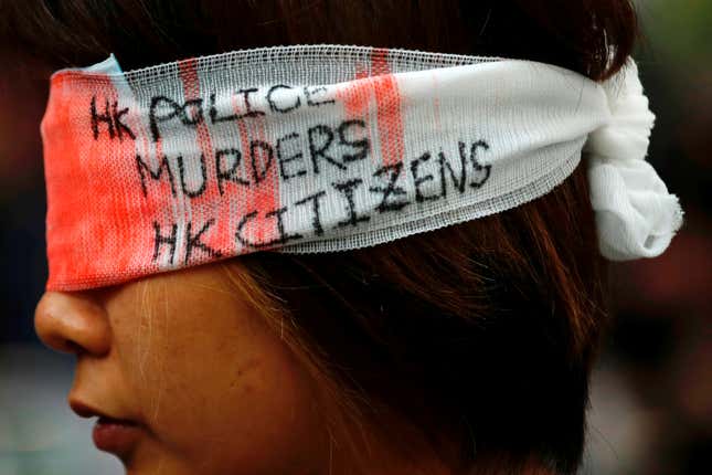 A protester covers her eye with gauze during a protest at Hong Kong International Airport, Aug. 12, 2019.