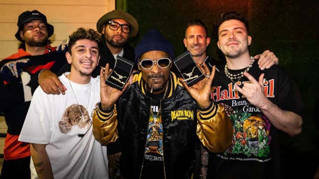 Snoop Dog poses with members of FaZe Clan after signing on as a member of the board of directors. 