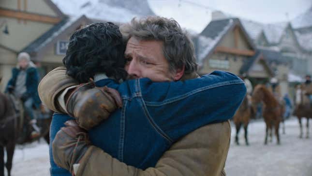 Joel and Tommy hug eachother in the snowy settlement of Jackson, Wyoming.