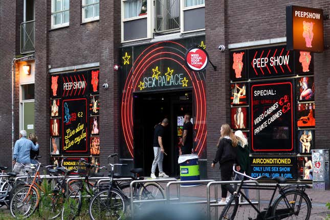 A picture of the red-light district in Amsterdam, specifically a storefront called "Sex Palace."