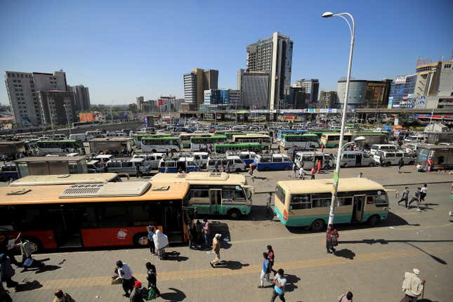 FILE PHOTO: People walk through Megenagna neighbourhood bus station in Addis Ababa, Ethiopia November 3, 2021