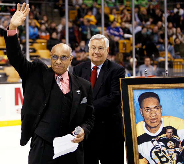 In this Jan. 19, 2008, file photo, former Boston Bruins hockey player Willie O’Ree waves to the crowd in Boston after being honored on the 50th anniversary of breaking the color barrier in the NHL after the first period of the Bruins hockey game against the New York Rangers in Boston.
