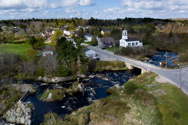 FILE - The Pleasant River flows through Columbia Falls, Maine, April 27, 2023. Plans to build the world&#39;s tallest flagpole are being delayed again. The town of Columbia Falls is extending its moratorium on big developments for another six months to allow more time to complete needed rules and regulations. (AP Photo/Rodrique Ngowi, File)
