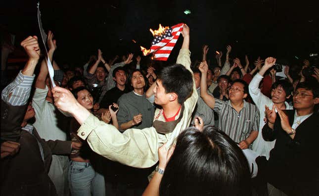 Student protesters burn an American flag outside the US embassy in Beijing.
