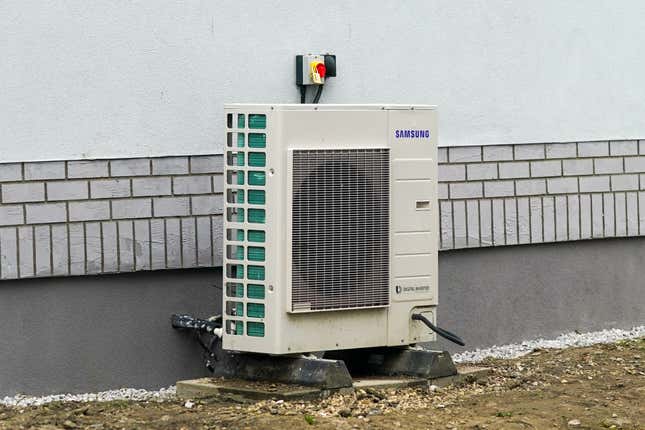 A heat pump stands outside a property as part of a green housing project.