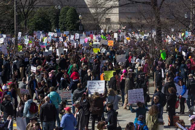 A view from atop a tree over the sea of marchers and signs below.