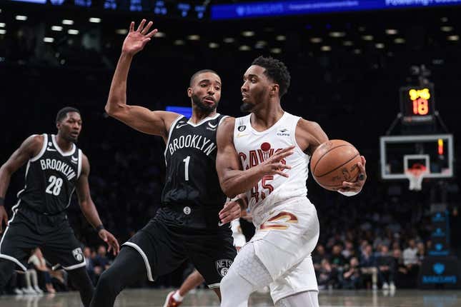 Mar 21, 2023; Brooklyn, New York, USA; Cleveland Cavaliers guard Donovan Mitchell (45) dribbles against Brooklyn Nets forward Mikal Bridges (1) during the first quarter at Barclays Center.