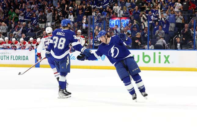 Mar 18, 2023; Tampa, Florida, USA;Tampa Bay Lightning left wing Brandon Hagel (38) is congratulated by center Brayden Point (21) after he scored a goal for a hat trick against the Montreal Canadiens during the third period at Amalie Arena.