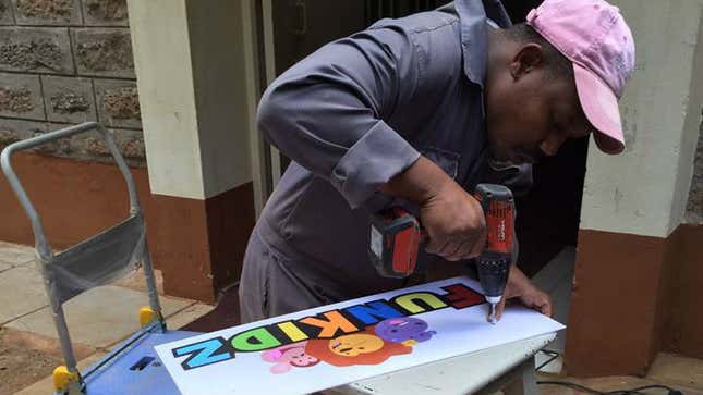 A FunKidz staffer making a sign for the store.