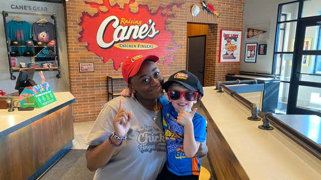 Raising Cane's employee smiling and posing with the birthday boy